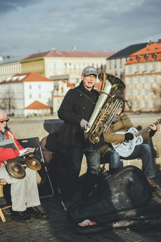 man in black suit playing brass saxophone